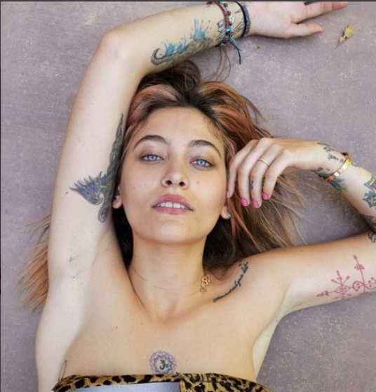 Topless Paris Jackson shows off her tattoos in a shoe campaign 