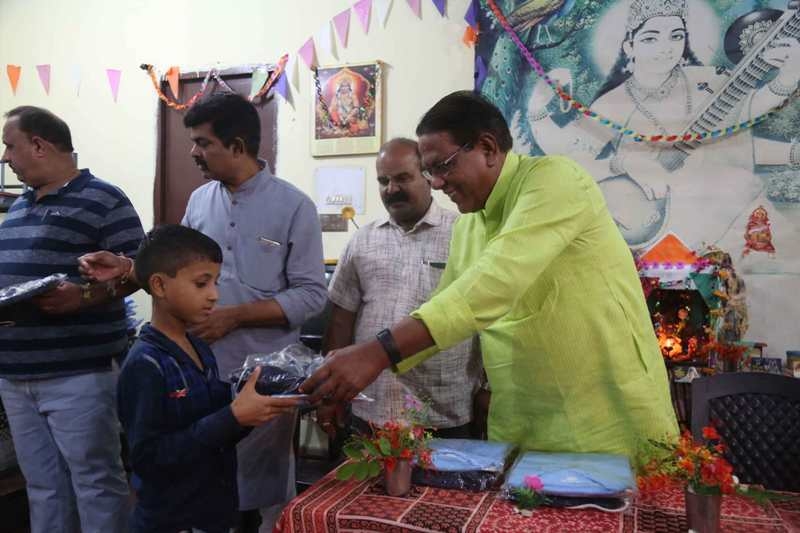 Revenue Minister Gupta distributes track suits to students