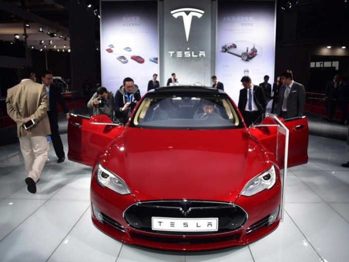  First Tesla Model 3 electric car rolling off production line 